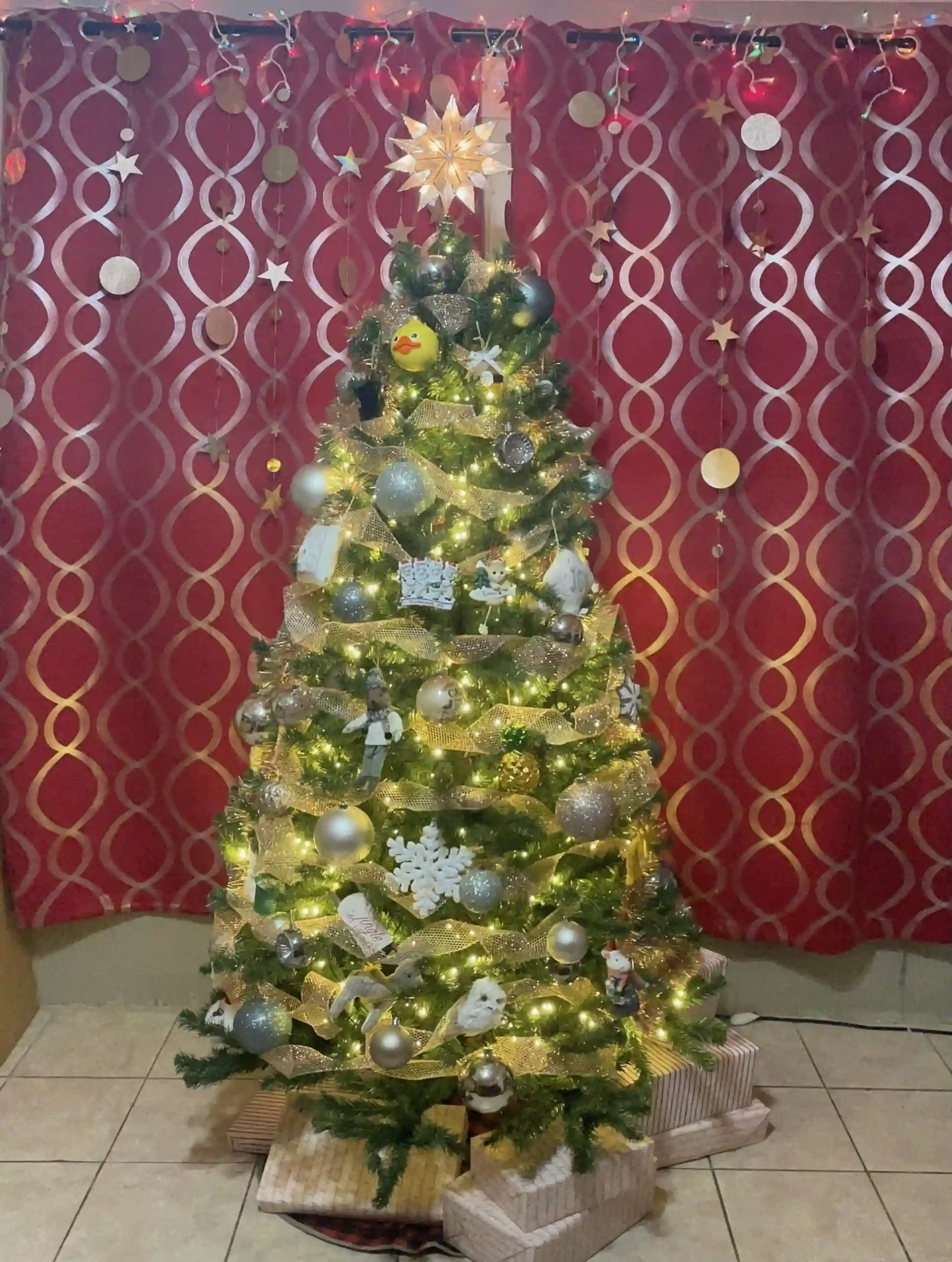 Christmas tree in front of a red curtain