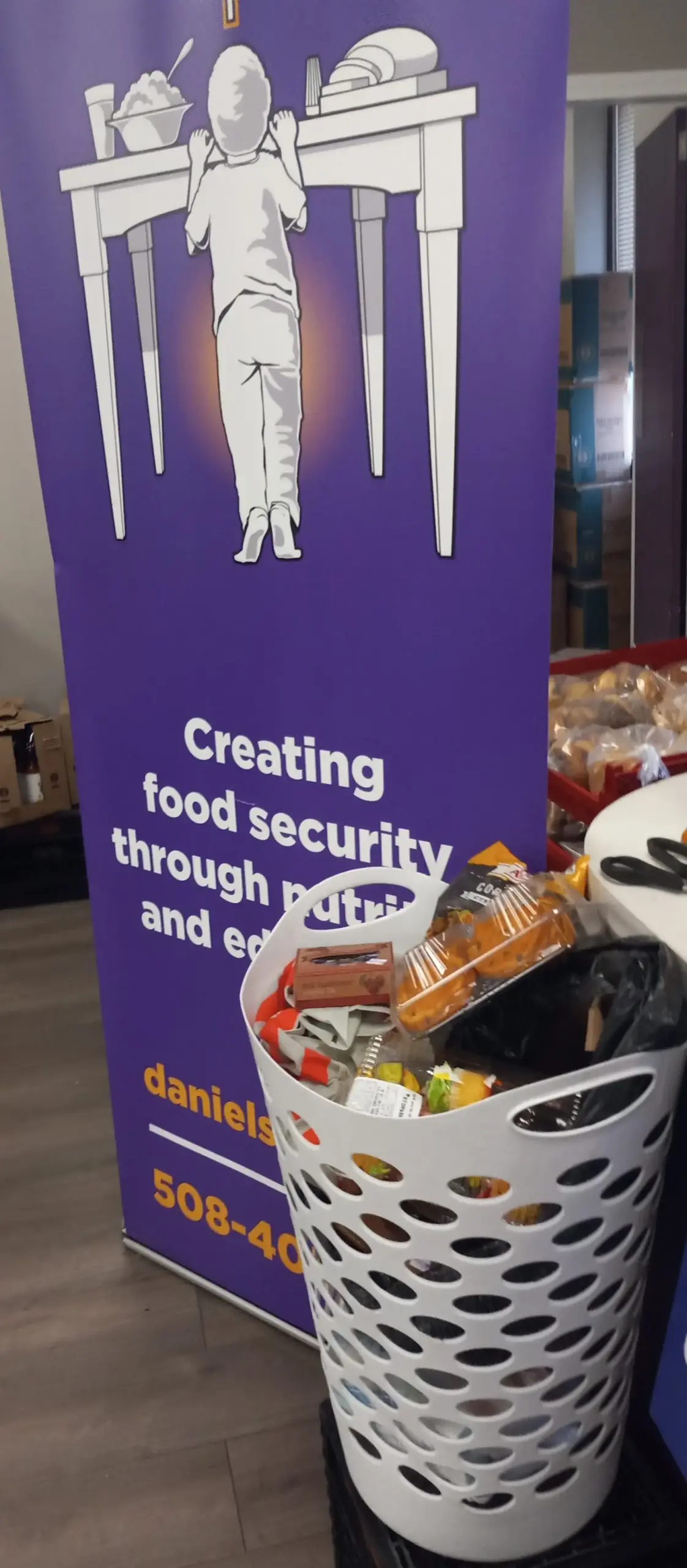 Food bank donations in front of sign