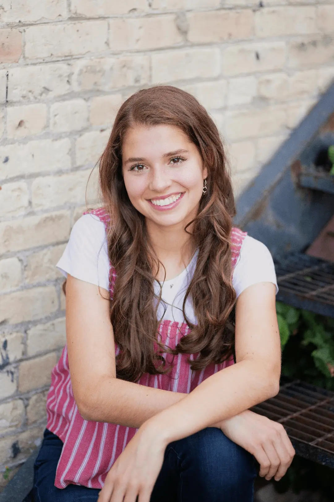 Smiling brunette woman on staircase