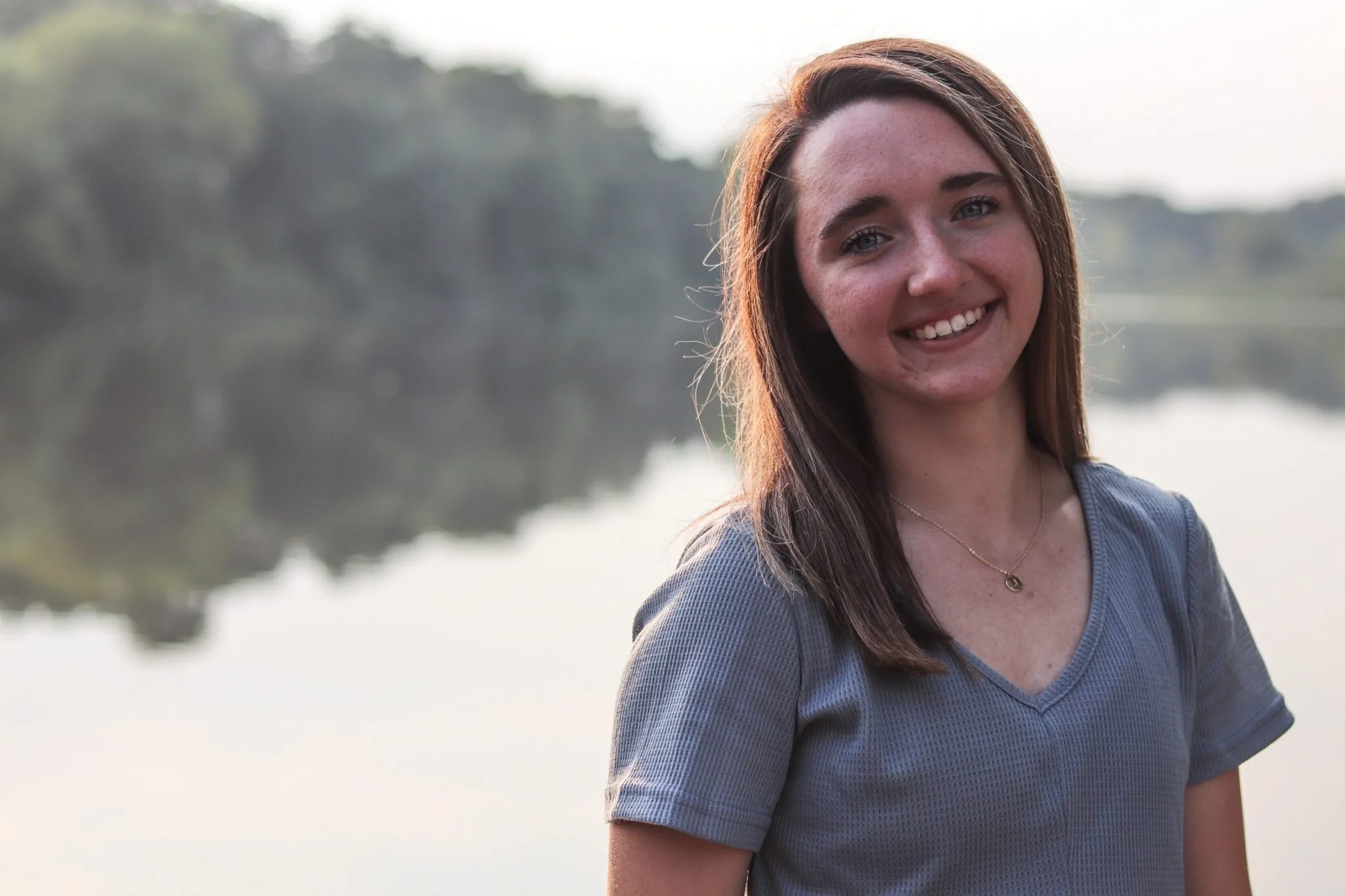 Smiling woman in front of lake