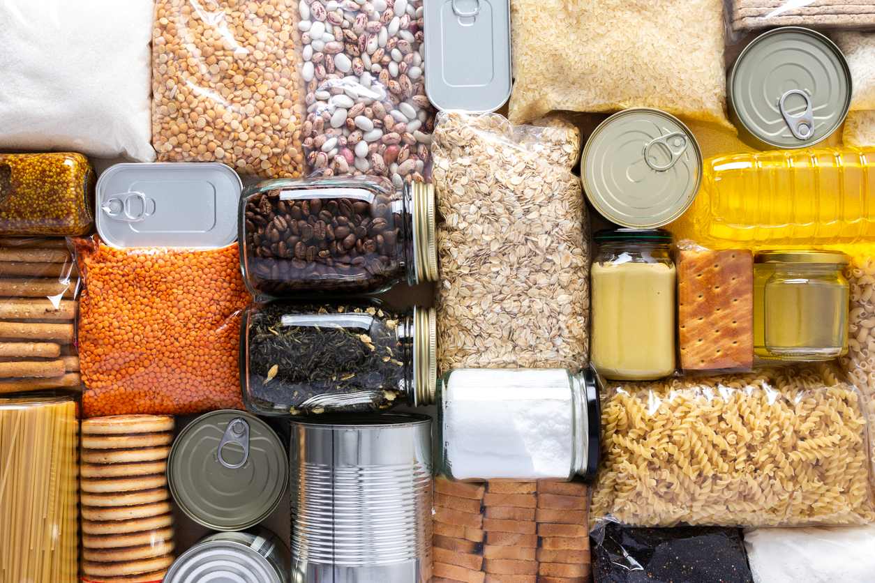 Food containers are organized and sealed to prevent pests in a pantry.